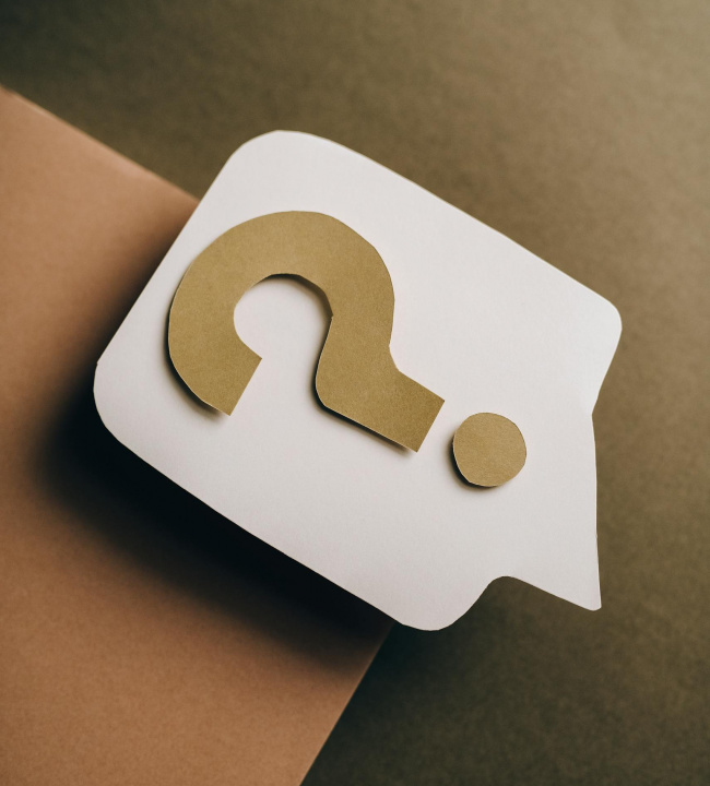 Artistic paper craft of a question mark on neutral background. Ideal for concept themes.
